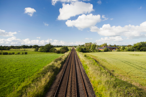 A straight railway stretching to the horizon in rural England.