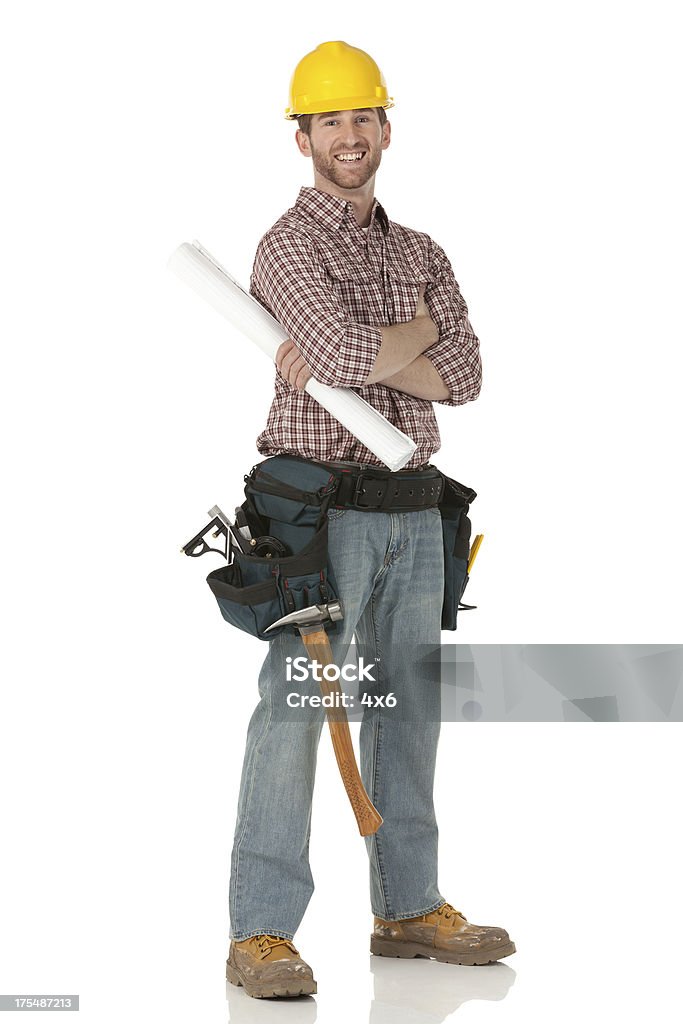 Happy carpenter standing with his arms crossed Construction Worker Stock Photo