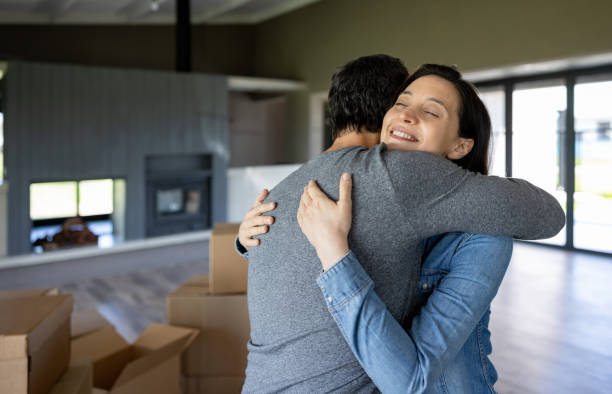 istock Happy couple hugging at home while moving house 1754872618