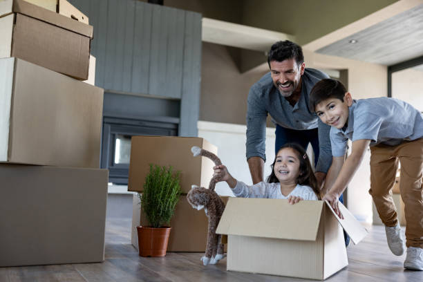 istock Happy father having fun with his children while moving house 1754872629