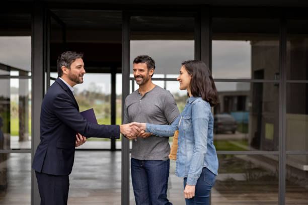 istock Real estate agent greeting a couple with a handshake 1754872648