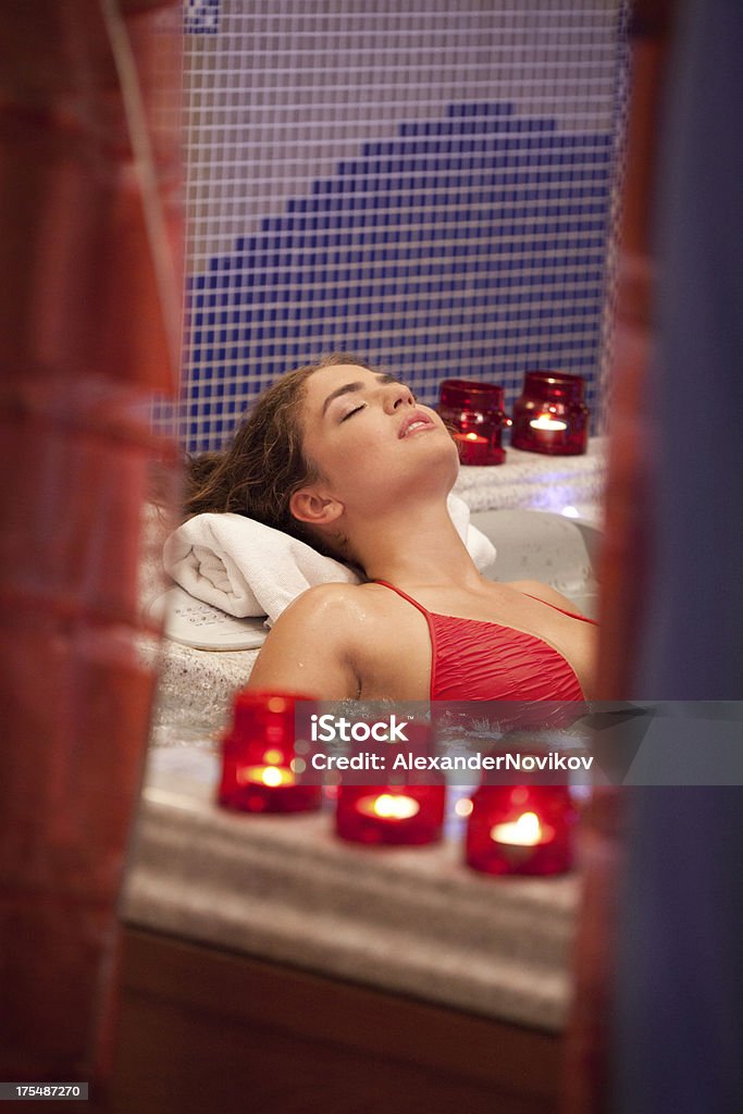 Young Beautiful Relaxing Woman  Lying in the Bath. Healthy Spa: Young Beautiful Relaxing Woman  Lying in the Bath. 20-29 Years Stock Photo