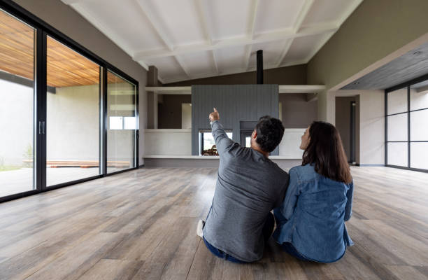 istock Happy couple moving to an empty house and thinking about decoration ideas 1754873134