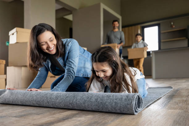 istock Family having fun unpacking the carpet while moving house 1754873197