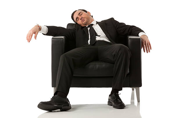 Businessman resting in an armchair Businessman resting in an armchairhttp://www.twodozendesign.info/i/1.png man sleeping chair stock pictures, royalty-free photos & images