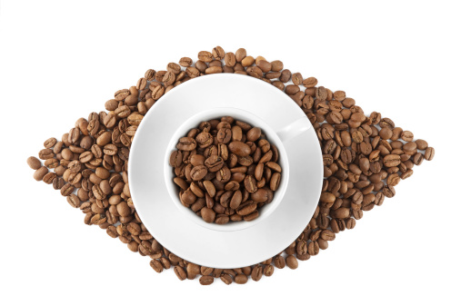 Raw coffee beans in white coffee cup. it looks like an open human eye...isolated on white.similar Coffee Images: