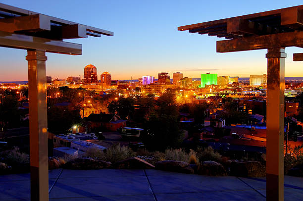 Albuquerque Downtown Albuquerque skyline at dusk. Albuquerque nighttime cityscape illuminated in vibrant colors such as green and blue. Albuquerque is the largest city in the state of New Mexico, United States. Albuquerque is known for its pleasant scenery, southwestern cuisine and International Balloon Fiesta.  bernalillo county stock pictures, royalty-free photos & images