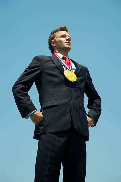 istock Proud Businessman Stands with Gold Medal 175488548