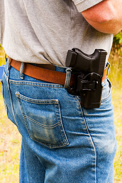 Open Carry "A modern, polymer (Glock), .45 caliber semiautomatic pistol in a belt holster (Blackhawk Serpa).All images in this series..." beja people stock pictures, royalty-free photos & images