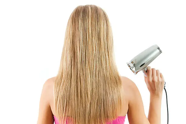 Woman with blonde hair holding hairdryer
