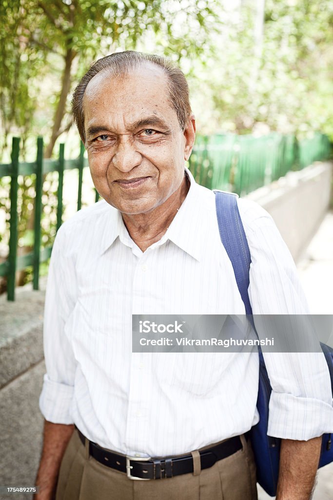 Cheerful Middle Class Indian Senior Man with Shoulder Bag View more Senior Indian Asian People... Culture of India Stock Photo