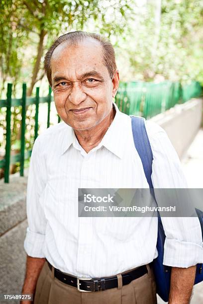 Cheerful Middle Class Indian Senior Man With Shoulder Bag Stock Photo - Download Image Now
