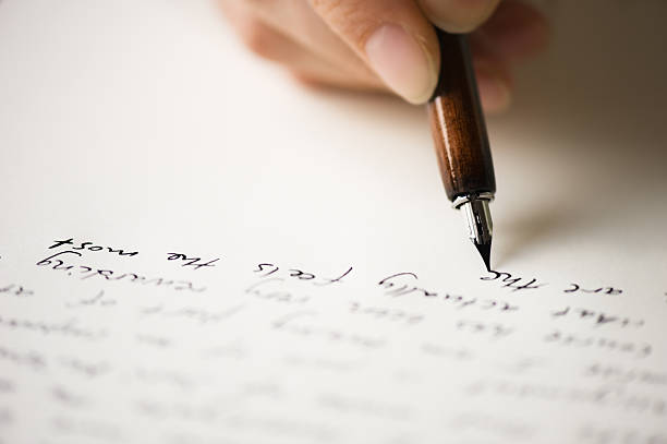 Writing letter to a friend Writing letter to a friend. Selective focus and shallow depth of field. the alphabet stock pictures, royalty-free photos & images