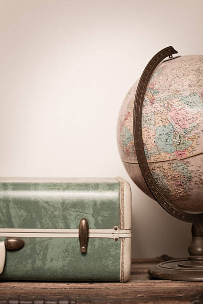 istock Retro Green Suitcase and Globe Sitting on Wood 175490703