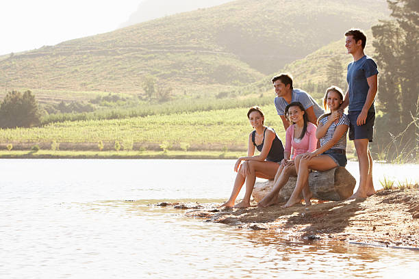 istock Young People Relaxing At Shore Of Lake 175490844