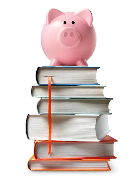 Photo of Piggy bank on stack of books