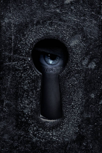 Eye Female eye looking through a keyhole  woman spying through a keyhole stock pictures, royalty-free photos & images