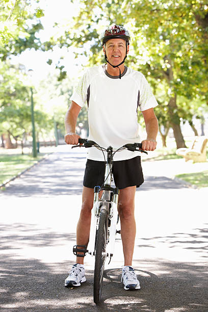 istock Mature Man Cycling Through Park 175491045