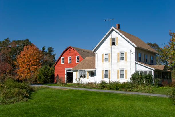 New England Farmhouse with red barn in autumn colors "Fall foliage and farmhouse in New England, USA." red barn house stock pictures, royalty-free photos & images