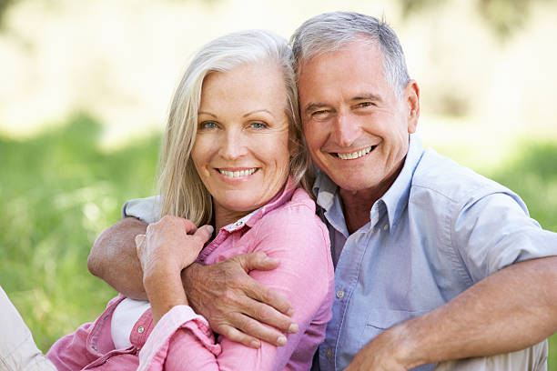 istock Senior Couple Relaxing In Sunny Summer Field 175492055