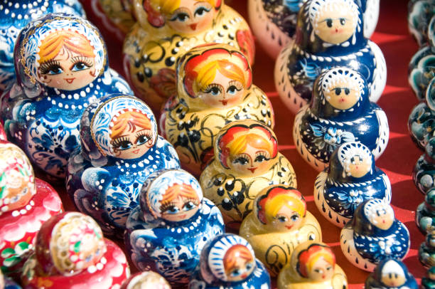 Babushka or Matryoshka Nesting Russian Dolls "Original Babushka or Matryoshka Nesting Russian Dolls in a raw. Colorful, hand painted nesting dolls - traditional symbol of Russia. Photo was taken in old bazaar in Moscow, Russia.See more images like this in:" russian nesting doll russia doll moscow russia stock pictures, royalty-free photos & images