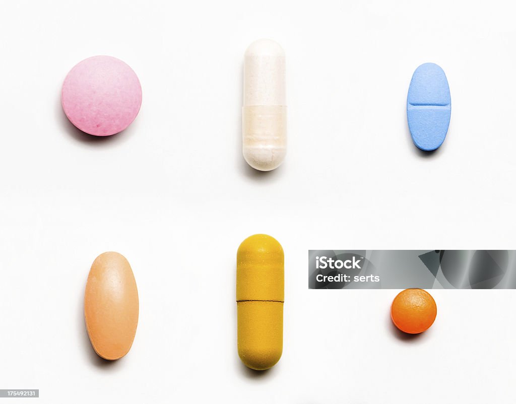 Medicine Rowed vitamins and pills on white background Capsule - Medicine Stock Photo