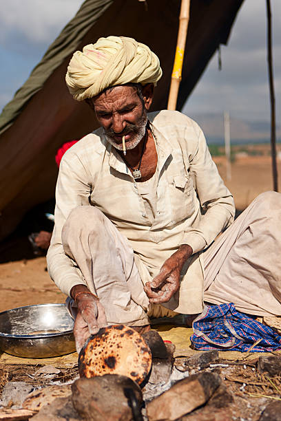 istock Indian men preparing chapatti bread during festival in Pushkar 175492295