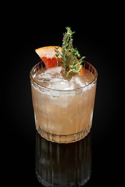 istock Grapefruit and Thyme Bourbon Smash Cocktail.  Drink in a glass on a dark background with reflection 1754924633