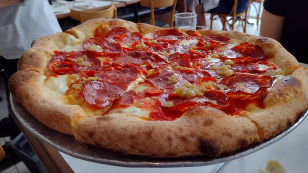 istock Whole meat pizza on rack in restaurant 1754927564