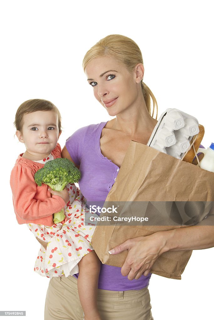 mom and toddler with groceries "mother and toddler food shopping together, isolated on white background" 12-17 Months Stock Photo