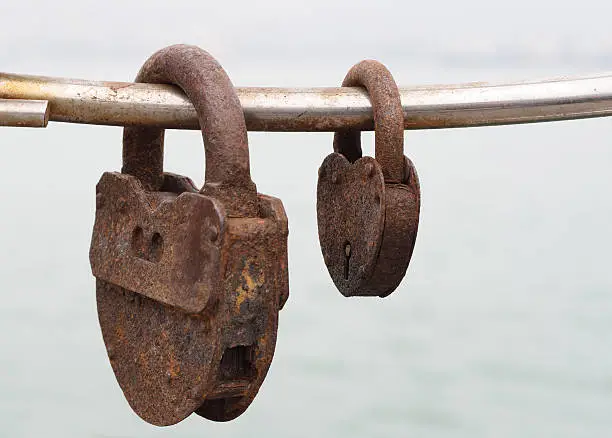 Two very rusty locks on the bridge, close-up,