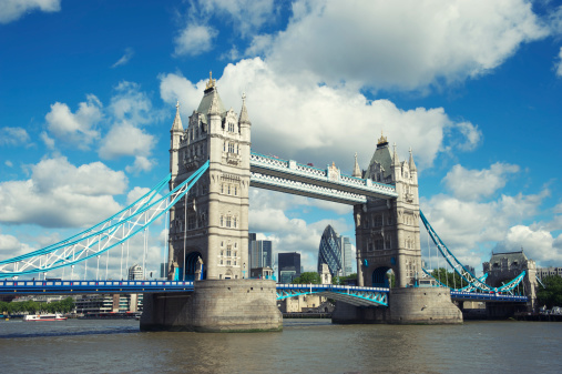 Classic view of Tower Bridge London with the River Thames and puffy white clouds