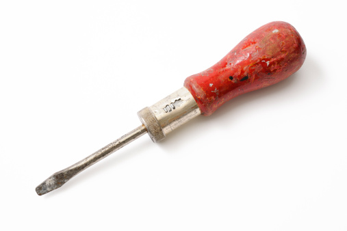 Old red screwdriver isolated on white background with clipping path.