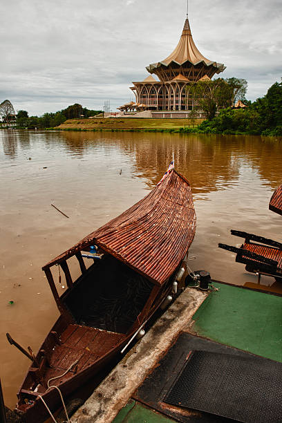 Traditional boat on river in Kuching stock photo