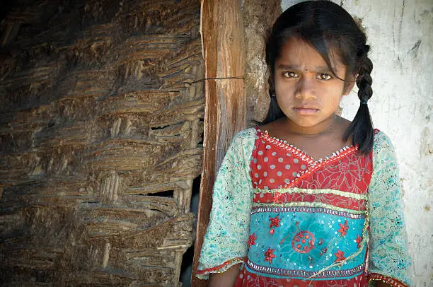 Photo of Young girl with pigtails, wearing rural clothes