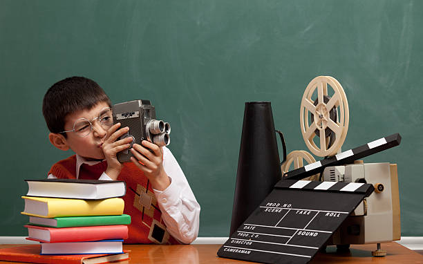 istock Little boy learning how to make film via video camera 175494152