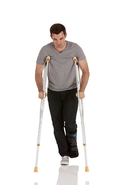 istock Man walking with the help of crutches 175494310