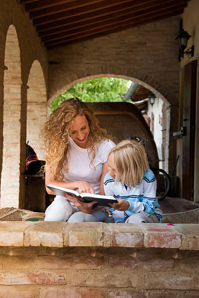 istock Young girl and children reading together 175494569