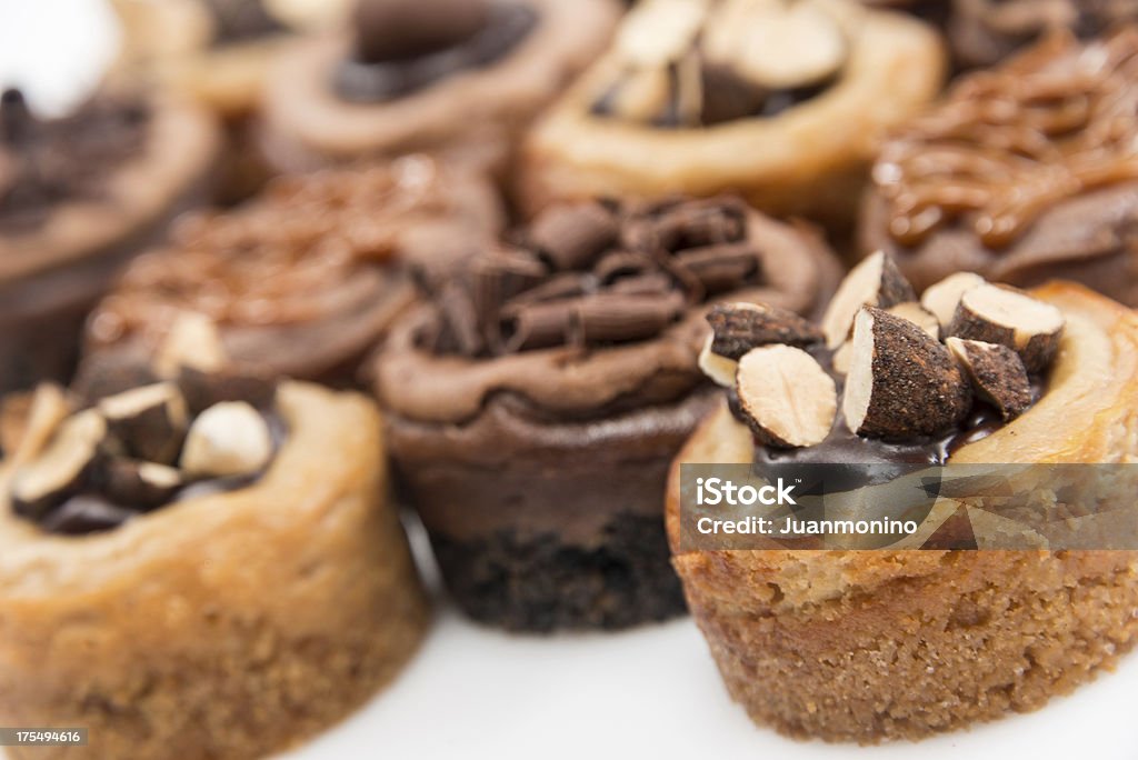 Assorted mini cheesecakes "Assorted mini cheesecakes in a row (chocolate, dulce de leche and almonds mini cheesecakes)" Almond Stock Photo