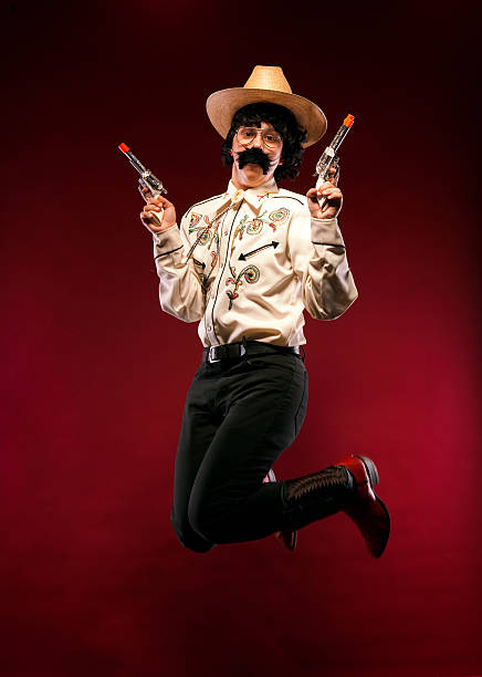 istock Jumping Cowboy with Toy Pistols and Leather Boots Studio Portrait 175494664