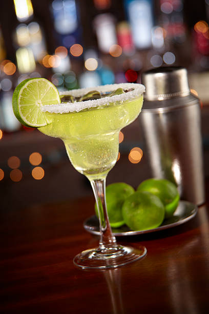 Margarita with salted rim and bokeh bar background stock photo