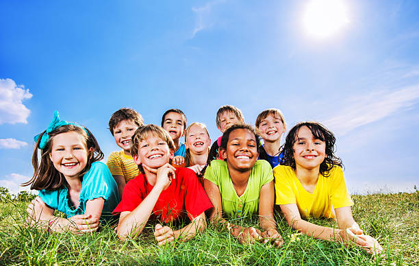 istock Happy kids lying in field and looking at camera. 175494850