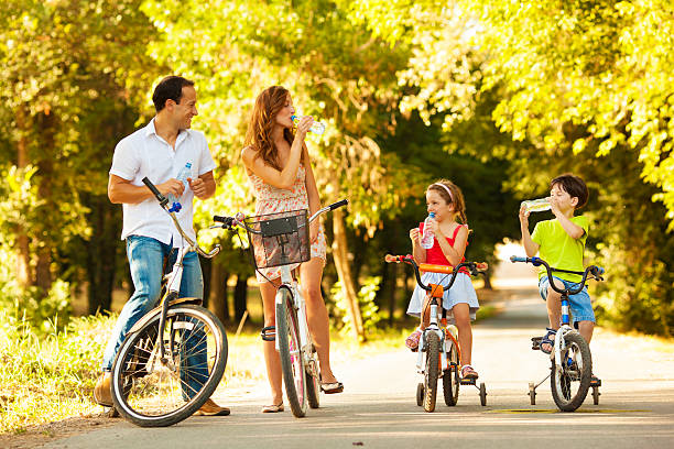istock Young family on bicycles in park 175494878