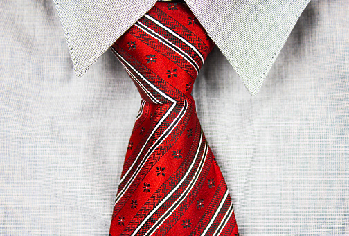 Light gray shirt and red tie, texture, background. Light shirt and red tie, men's business style.