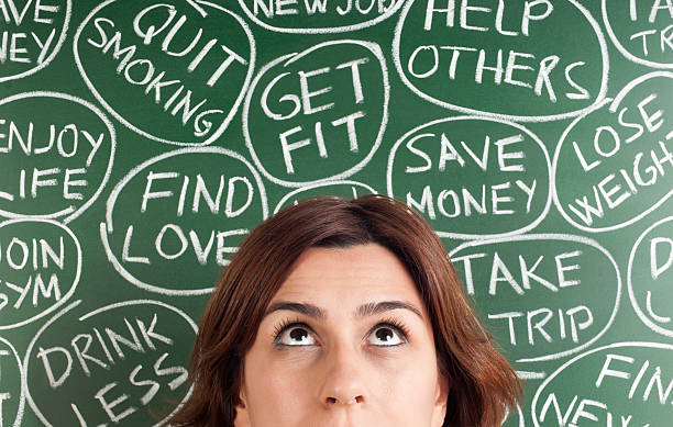 istock A woman thinking of different New Years resolutions 175495284