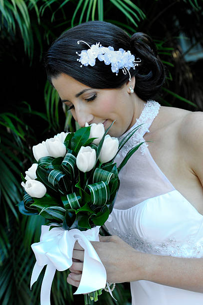 Bride taking in the scent of her bouquet
