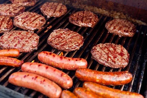 Photo of Barbeque Grill with Hamburgers hot dogs and sausage