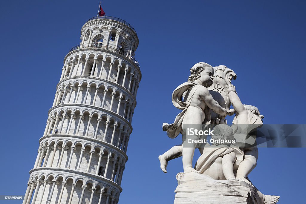 Leaning Tower of Pisa with Statue of Cherubs, Pisa, Italy The famous leaning tower with Statue of Cherubs (Fontana dei Putti) Architecture Stock Photo