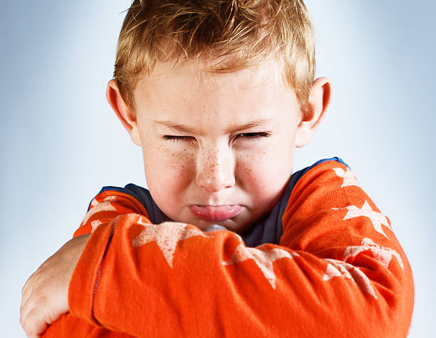 istock Furious little boy pouts and narrows his eyes in rage 175496125