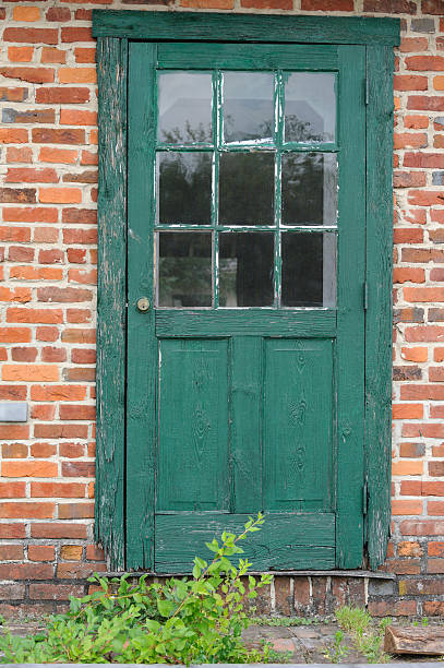 istock Green Door in old Red Brick Building, Abandoned with Weeds 175496155